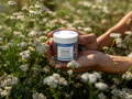 Woman applying cream on her face